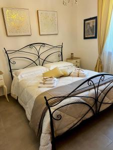a bedroom with a black bed with towels on it at Il Refolo in Norcia