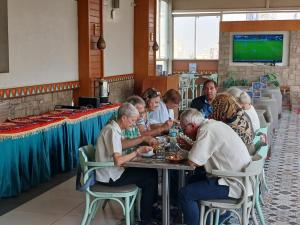 a group of people sitting at a table in a restaurant at Almadiafa - المضيفه in Cairo