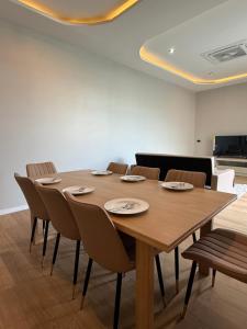 a wooden table and chairs in a room at An An Pool Villa in Nong Prue