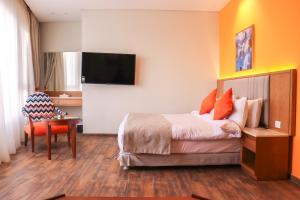 a hotel room with a bed and a table at Almadiafa - المضيفه in Cairo