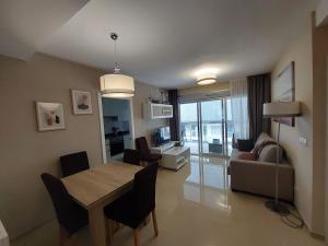 a living room with a dining room table and a couch at Luc61 - Vistas al mar in La Estación