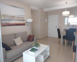 a living room with a couch and a table at Luc61 - Vistas al mar in La Estación