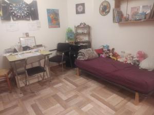 a room with a bed with stuffed animals on it at Fab's Home in Oust
