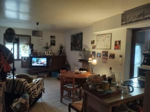 a living room with a table and a tv at Fab's Home in Oust