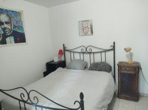 a bedroom with a bed and a picture on the wall at Fab's Home in Oust
