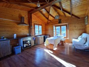 a large living room with wooden walls and wooden floors at Casa de la Hoz in Calomarde