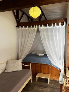a bedroom with a bed with a canopy at Sandra Studio in Lachania
