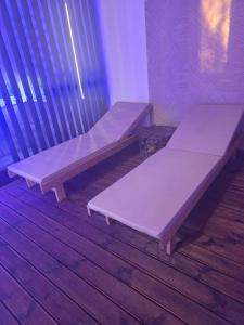 two purple benches sitting in a room at D&A Vila - Private Villa with Sauna & Hot Tub in Arciūnai +5 photos