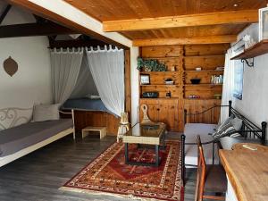a bedroom with a bed and a couch and a table at Sandra Studio in Lachania