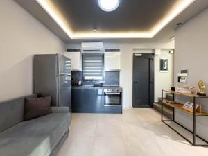 a living room with a couch and a kitchen at Assos Luxury Villas in Pefkochori +51 photos