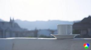 a white coffee cup sitting on top of a ledge at Atlantis Apart Hotel in Marmaris +5 photos
