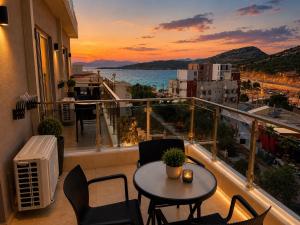 a balcony with a table and chairs and a view of the ocean at Hotel Mare in Ksamil