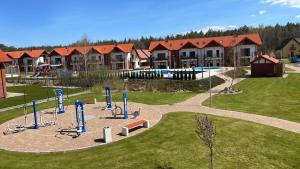 a park with a playground in front of a building at Łebska ostoja in Żarnowska