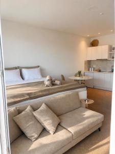 a bedroom with a large bed and a couch at Almyra Suites in Archangelos +15 photos