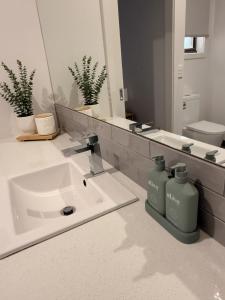 a bathroom with a sink and a mirror at Shell Escape at Ocean Grove in Ocean Grove +46 photos