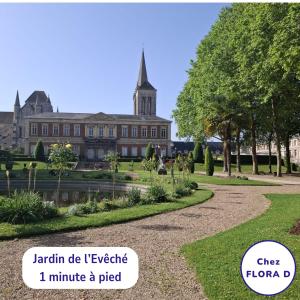 a building with a clock tower in the background at Chez FLORA D - Lisieux hypercentre - in Lisieux