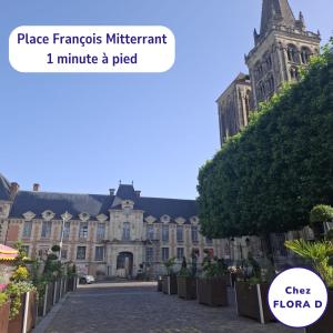 a picture of a building with a sign that reads place famous migrant minute at Chez FLORA D - Lisieux hypercentre - in Lisieux