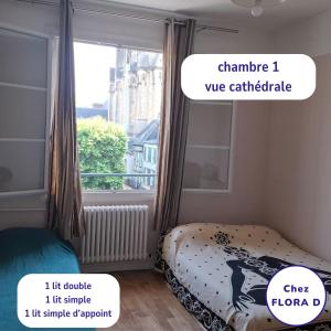 a bedroom with a bed and a window at Chez FLORA D - Lisieux hypercentre - in Lisieux