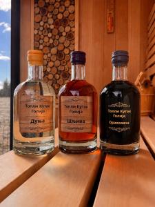 three bottles of whisky sitting on top of a table at Topli kutak Golija in Novi Pazar