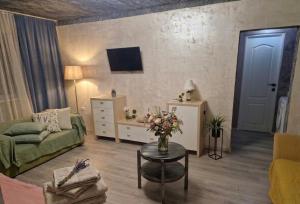 a living room with a couch and a table at Old City Cafe in Brăila +4 photos