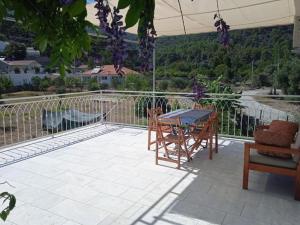 a patio with a table and chairs and a view at Mavi Ev in Köyceğiz