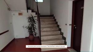 a staircase with a potted plant in a room at CliVio - By Ligooria in Pietra Ligure