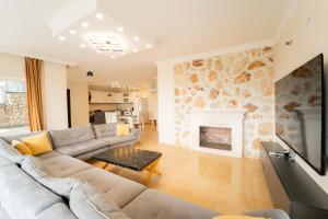 a living room with a couch and a fireplace at Villa Mevsim in Kaş