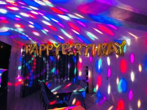 a party with a happy birthday sign and lights at Cabana Ursu in Iaşi