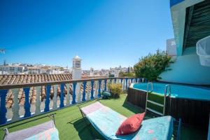 a balcony with a bench and a swimming pool at Villa 2BDR with sea view, private pool in Albufeira +51 photos