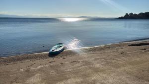 a boat on the shore of a body of water at Thalia- 2 Bedroom Beachfront Apartment! in Lefokastro