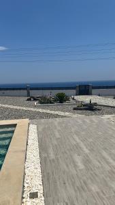 a view of a beach with a pool and the ocean at Onar Luxury Villa - Adults Only in Lachania