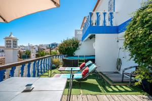 a balcony of a house with a table and chairs at Villa 2BDR with sea view, private pool in Albufeira