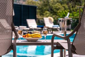 a table with a bowl of fruit and glasses of wine at Villa Ekinoks in Kalkan
