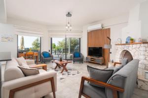 a living room with couches and a fireplace at Villa Ekinoks in Kalkan