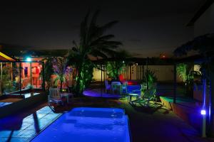 a swimming pool at night with blue lights at Villa wagmaker Jesús está voltando in São Miguel do Gostoso