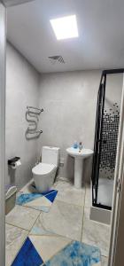 a bathroom with a toilet and a sink at "Private Room in New Luxury " Apartment in Ulaanbaatar