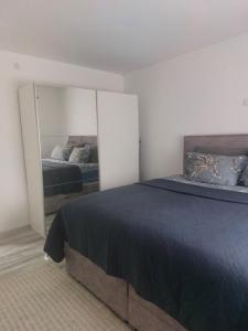 a bedroom with a bed and a mirror at Apartman Sava in Bosanski Šamac