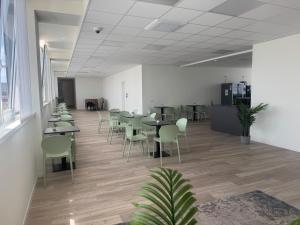 a dining room with tables and chairs in an office at SPACE101 City Apartment & Studio in Limito di Pioltello