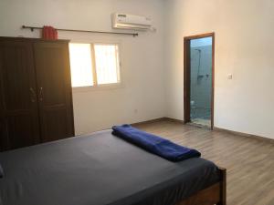 a bedroom with a bed and a large mirror at Chez Roseline in Ndangane +7 photos
