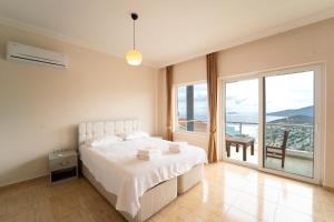 a bedroom with a bed and a large window at Villa Mevsim in Kaş +32 photos
