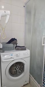 a washer and dryer in a corner of a bathroom at Апартаменты в центре in Chernihiv