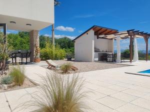 a patio with a building and a table and chairs at Lazy 8 Villa in Garica