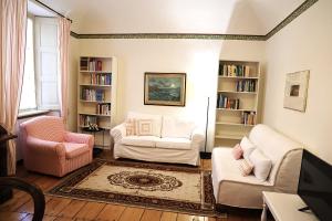 a living room with white furniture and bookshelves at Teddy Bear trilocale, family, centro Biella in Biella