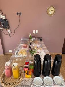a table with food and plates on top of it at Professor Guest House in Santo Amaro