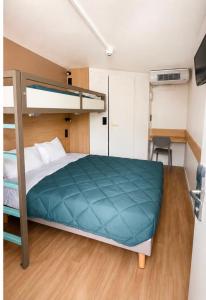 a bedroom with a bunk bed and a desk at Première Classe Tarbes - Bastillac in Tarbes