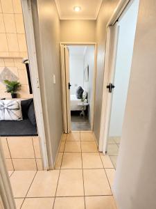 a hallway with a door leading to a bedroom at Zhantique Guest House 2- Unit 6 in Boksburg