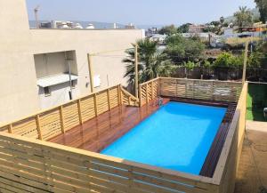 a swimming pool on top of a house at Domos Tiberias - Heated pool דומוס טבריה- בריכה מחוממת דקת הליכה לממד in Tiberias