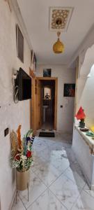 a living room with a tiled floor and a tv at Apprt Ennakhil 1 in El Jadida