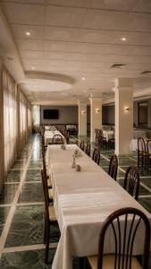 a conference room with tables and chairs and a television at Aia del vento in Cisternino +18 photos