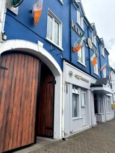 a large blue building with a large wooden door at Kilian's Lodge Hotel in Mullagh